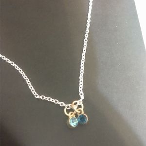 silver necklace with blue gemstones